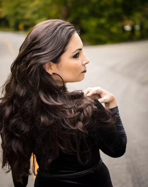 Model with long wavy dark brown hair extensions